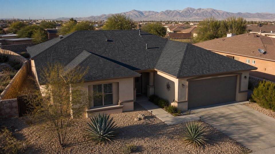 Charcoal architectural shingle roof on an El Paso stucco home